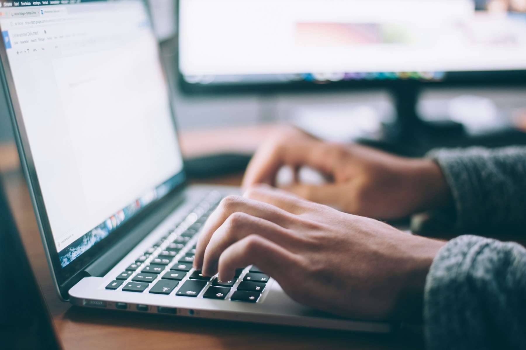 Drafting an application essay on a laptop